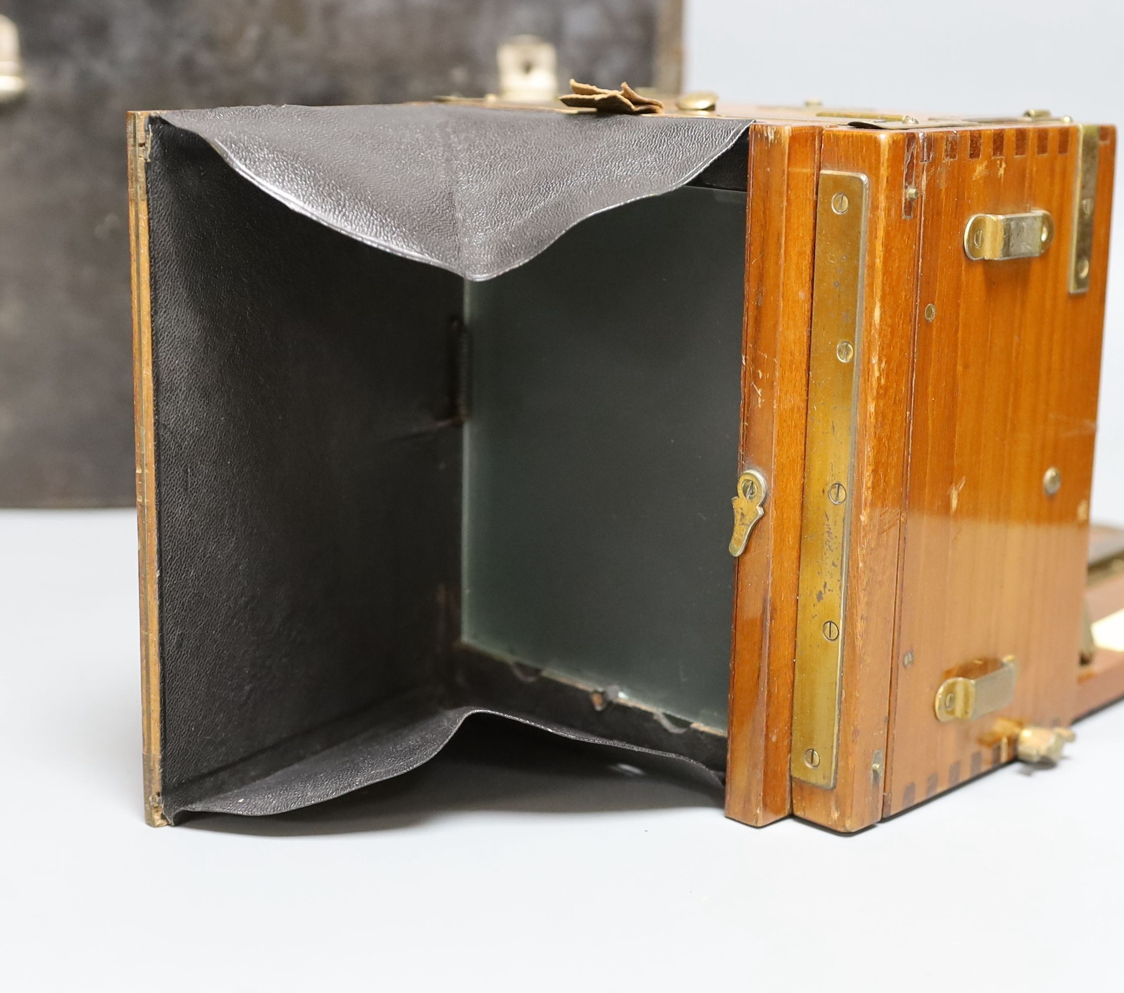 A Sanderson ‘Tropical Model’ plate camera, leather cased with various mahogany plate holders.